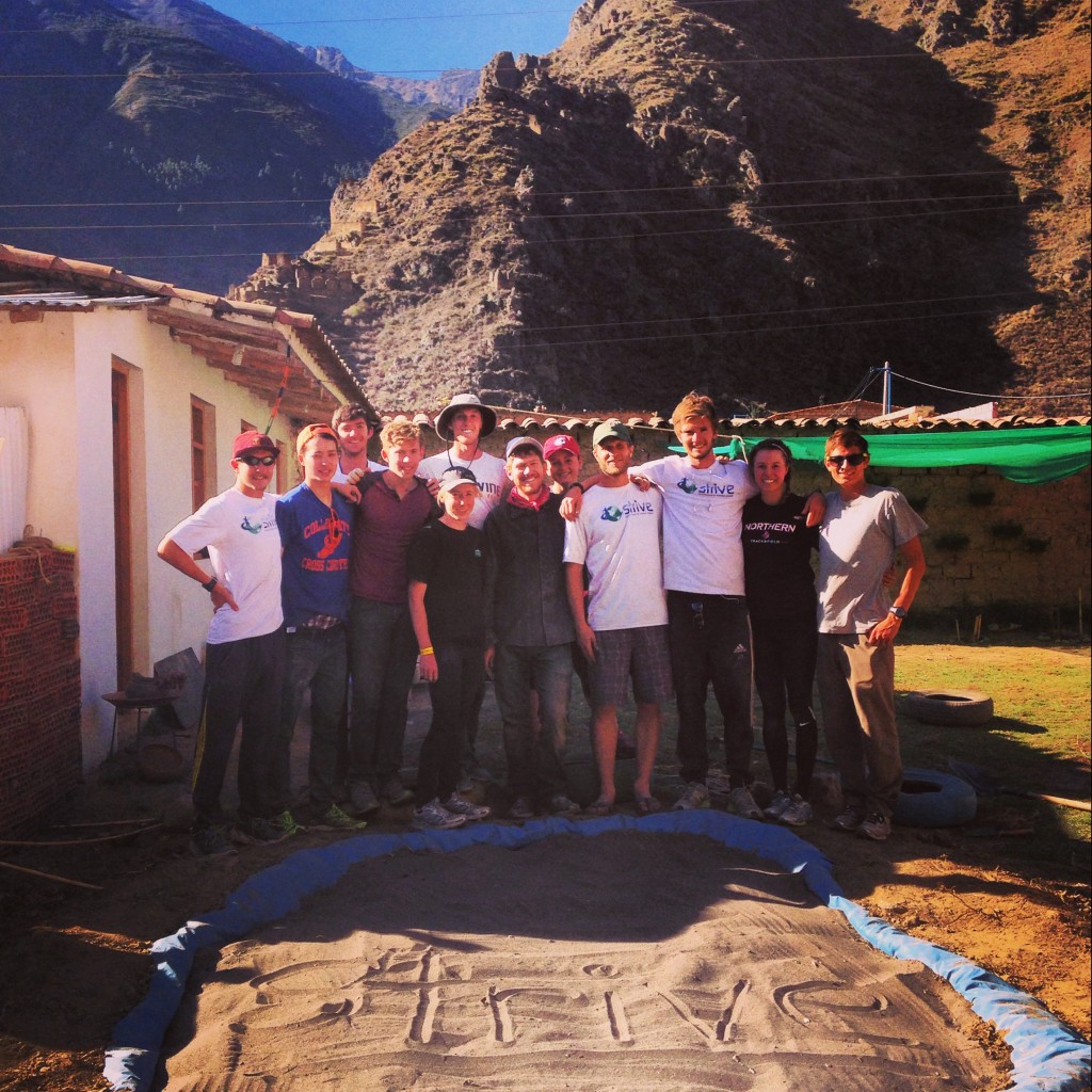 STRIVE interns and staff posing next to the sand box - one of several projects accomplished in this one-day service spree in Ollantaytambo!