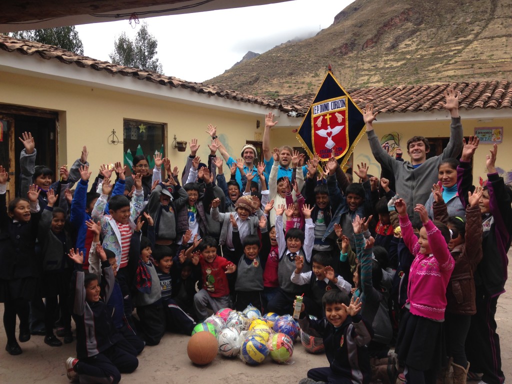 STRIVErs posing with Divino Corazon students and faculty and some of the new sports balls to start off the new PE program!